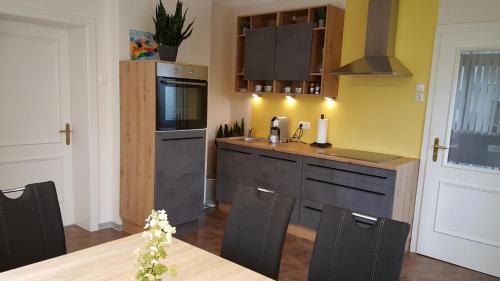 a kitchen with a table and a counter top at Ferienwohnung Corinna in Fehring