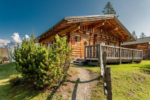a log cabin with a porch and a deck at Almwelt Austria in Schladming