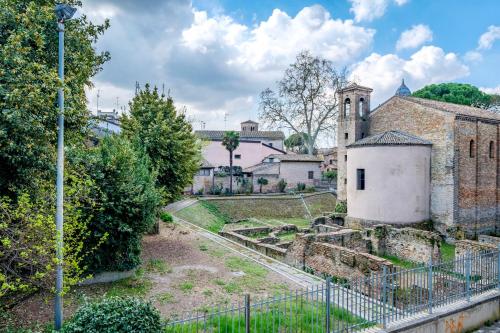 an old building with a tower and a church at Casa Pimpotta in Ravenna