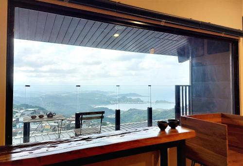 a large window in a room with a view at Dosun B&B in Jiufen