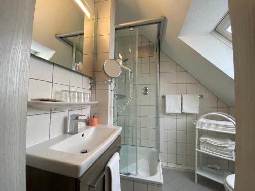 a bathroom with a sink and a shower at Hotel Garni Wiestor in Überlingen