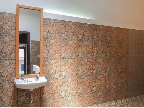 a bathroom with a sink and a mirror at RedDoorz Resort near Darajat Garut in Garut