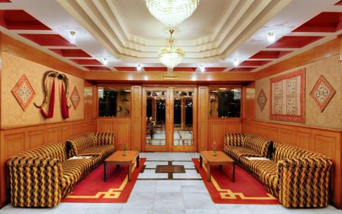 a lobby with couches and tables in a building at Shingar Regency in Manāli
