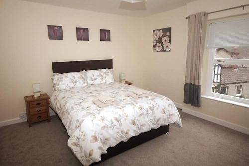 Un dormitorio con una cama grande y una ventana. en No 28B St Benedict, en Glastonbury