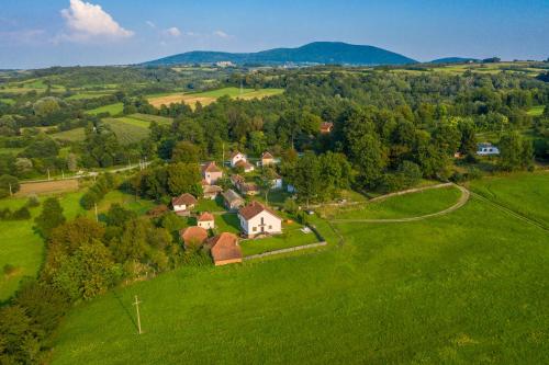 an aerial view of a house in a green field at Kosmaj Casa Maia in Dučina