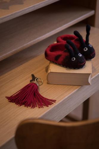 a shelf with a book and a pair of tassels at Hotel Goldener Ochs in Bad Ischl