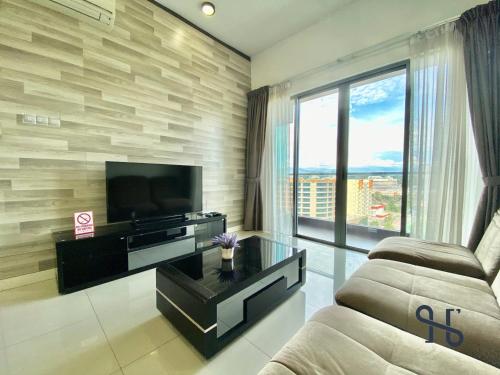 uma sala de estar com uma televisão e um sofá em Homesuite' Home at The Loft em Kota Kinabalu