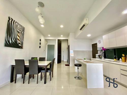 a kitchen and dining room with a table and chairs at Homesuite' Home at The Loft in Kota Kinabalu