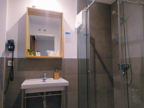 a bathroom with a sink and a shower at Pensión Sarriegi in Donostia-San Sebastián