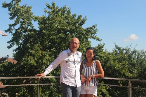 a man and a woman standing next to a fence at le chemin du meunier in Riquewihr