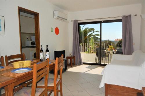 a living room with a table and a dining room with a view at Solar dos Vilarinhos - By bedzy in Albufeira