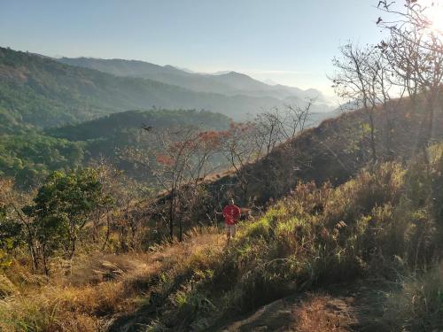 a person walking up a hill on a trail at Beyond Eco Living in Munnar