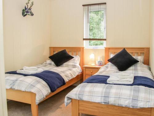 Postelja oz. postelje v sobi nastanitve Alder River Lodge Clun Valley Luxury Hot Tub Break