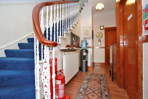 a staircase in a home with a blue and white stair railing at CitiHouse Aberdeen West End in Aberdeen