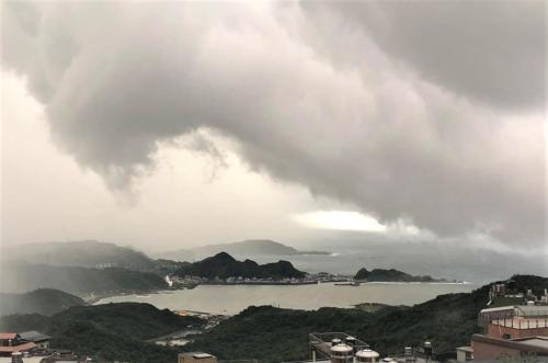 a view of a body of water under a cloudy sky at Dosun B&B in Jiufen