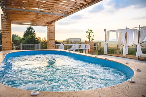 a hot tub on the patio of a house at 103 Degrees Hotel & Spa in Sapareva Banya