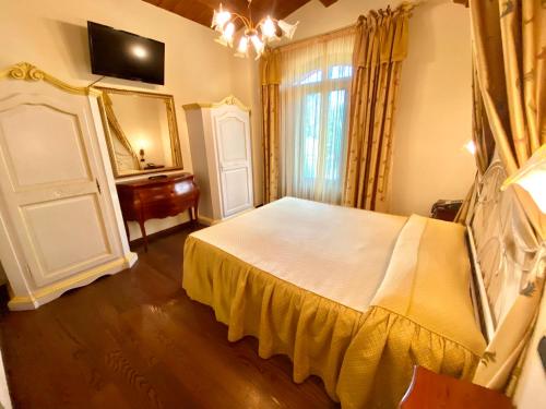 a bedroom with a bed and a dresser and a mirror at Agriturismo Il Casale in Morrovalle