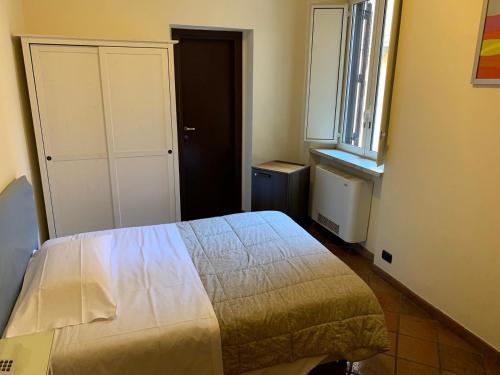 a small bedroom with a bed and a window at Hotel Croce Di Malta in Rome