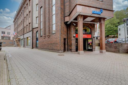 an empty street in front of a brick building at University City Heart, Tartu Home in Tartu