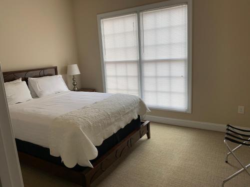 a bedroom with a bed and a large window at Cottages and Suites at River Landing in Wallace
