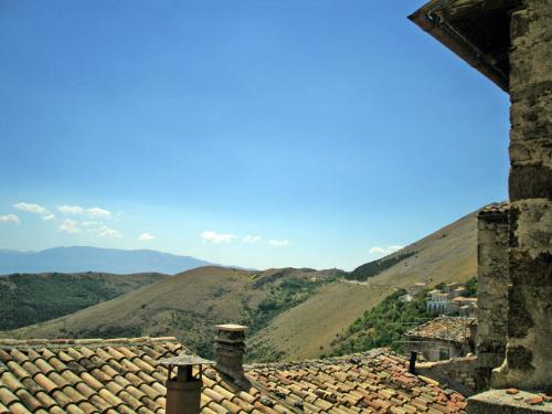 a view of the mountains from the roof of a building at Le Case Della Posta in Santo Stefano di Sessanio