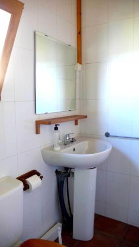 a bathroom with a white sink and a mirror at Camping Aín Jaca in Jaca