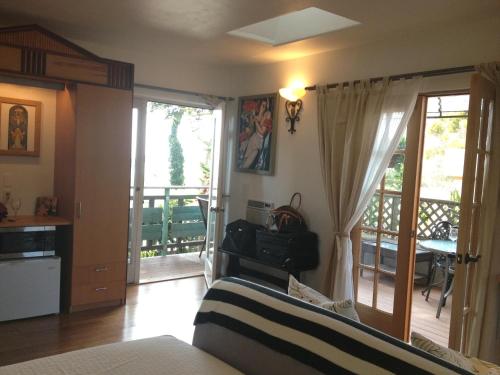 a living room with a bed and a balcony at Les Artistes Inn in San Diego