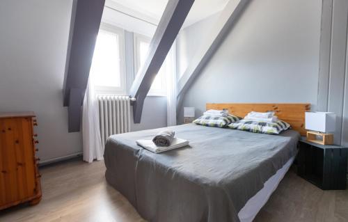 a bedroom with a large bed with a wooden headboard at La Belle Arverne in Albepierre-Bredons