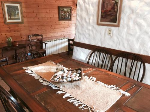 a wooden table with a bowl of eggs on it at Cruz del Sur in Pinamar