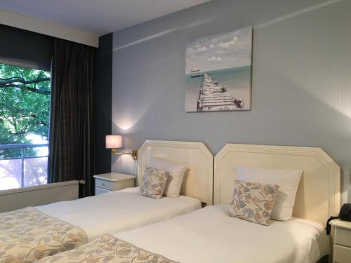 Postel nebo postele na pokoji v ubytování First Euroflat Hotel