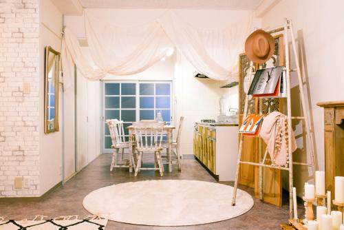 a kitchen with a table and a window at Meee Kameari in Tokyo
