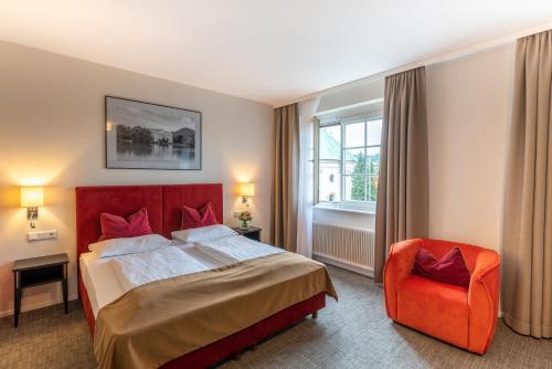a hotel room with a bed and a dresser at Hotel Wolf Dietrich in Salzburg