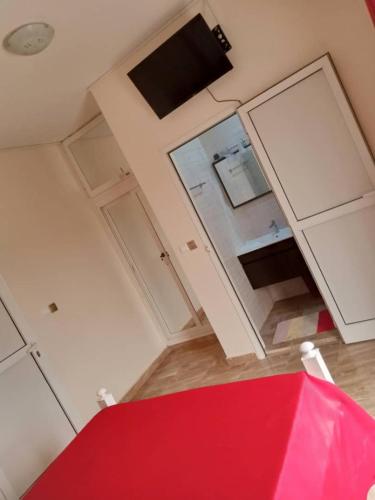 a kitchen with white cabinets and a red rug at Residence Saint James in Somone
