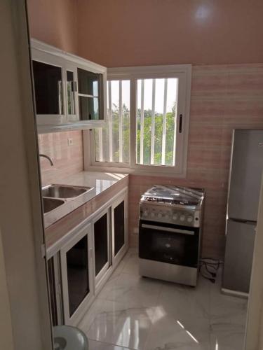 a kitchen with a sink and a stove at Residence Saint James in Somone