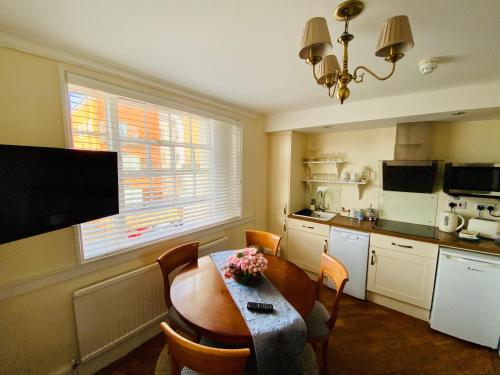 a kitchen with a dining room table and a kitchen with a tableablish at Pier View Self Catering Luxury Apartments in Southend-on-Sea