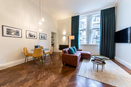 a living room with a couch and a table at Linton Collection - 28 North Bridge in Edinburgh