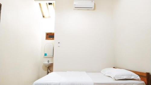 Tempat tidur dalam kamar di Dapur ethnic guesthouse