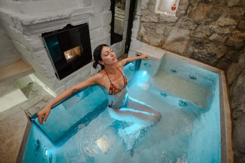 a woman is sitting in a hot tub at Egò Salento in Galatina