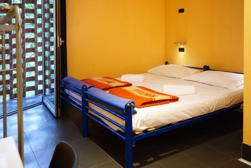 a hospital bed with towels on it in a room at Hi! Ostello Milano in Milan