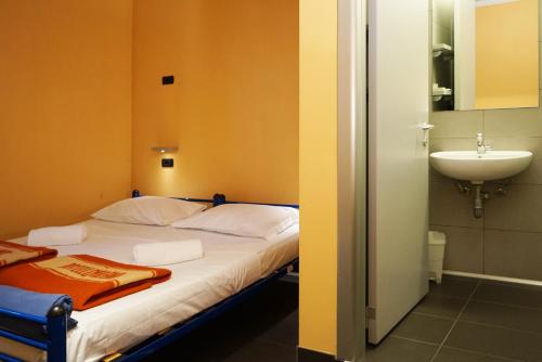 A bed or beds in a room at Hi! Ostello Milano