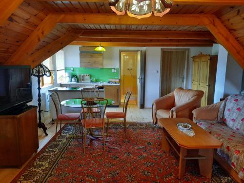 a living room with a couch and a table at Novohradský ráj aneb Oáza klidu na samotě u lesa in Benešov nad Černou