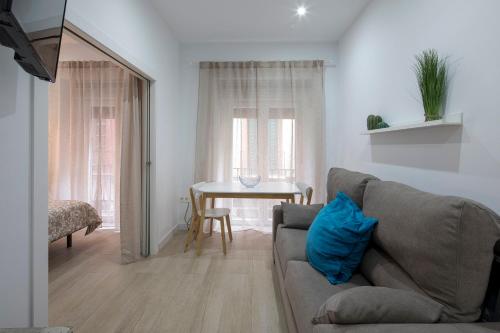 a living room with a couch and a table at ROSE Apartamentos in Granada
