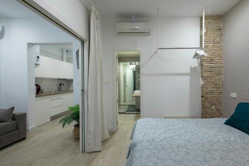a bedroom with a bed and a large mirror at ROSE Apartamentos in Granada