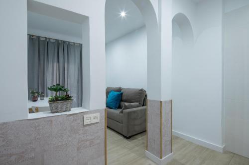 a living room with a couch and a window at ROSE Apartamentos in Granada