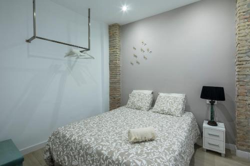 a bedroom with a bed with a pillow on it at ROSE Apartamentos in Granada
