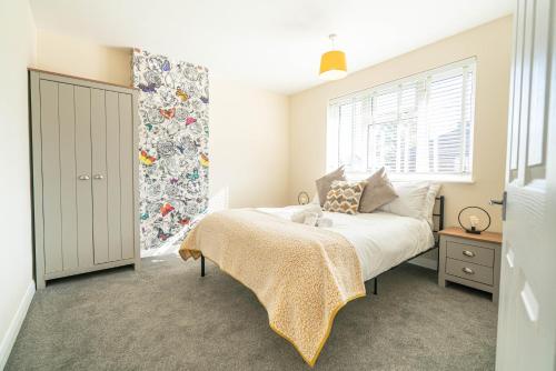 a bedroom with a bed and a window at Modern 3 Bed House in Sidcup, Parking in Sidcup