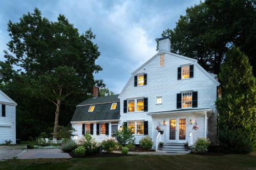 a white house with lights on at Waldo Emerson Inn in Kennebunkport