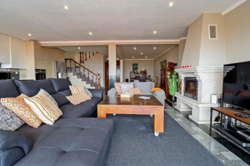 a living room with a couch and a fireplace at Vila Lucia in Vila Praia de Âncora