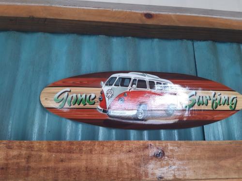 a surfboard with a drawing of a car on it at Little Camelot in Langebaan