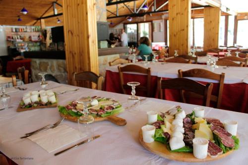 a plate of food on a table in a restaurant at Agriturismo Maneggio Vallecupa in Pescasseroli